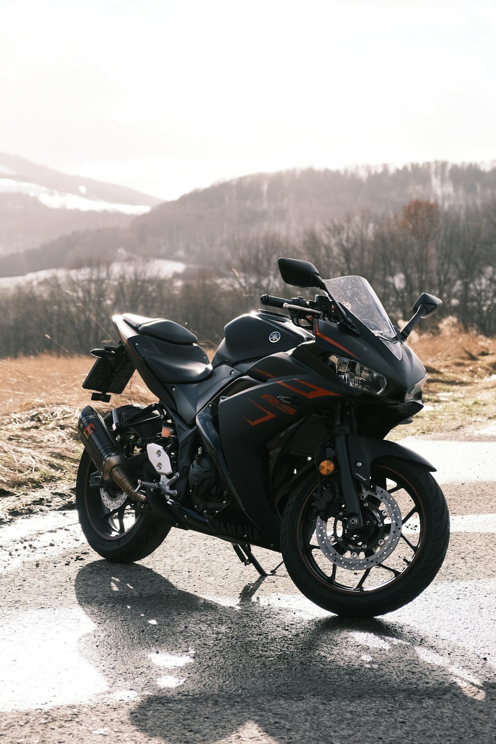 a black motorcycle parked on the side of a road