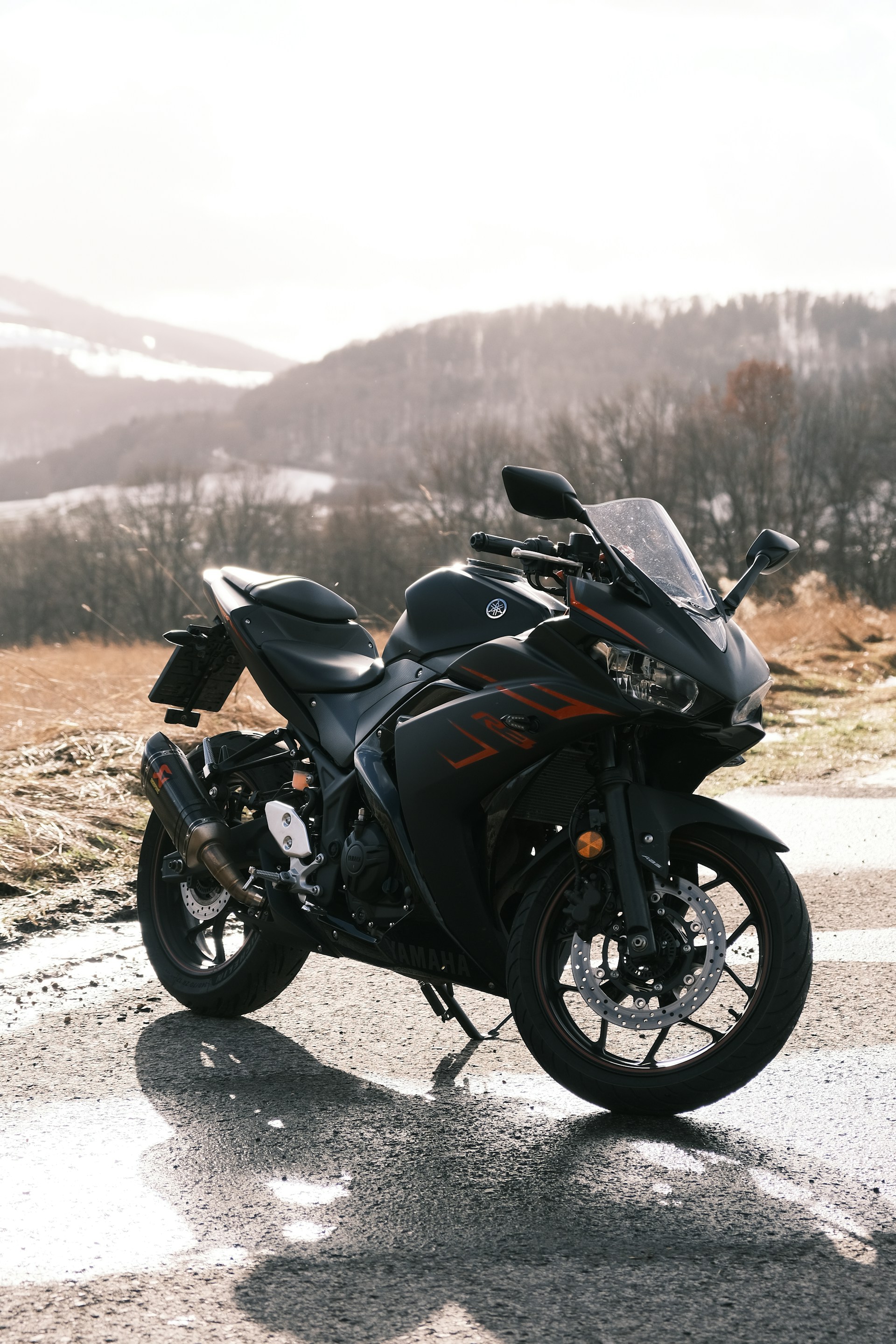 a black motorcycle parked on the side of a road