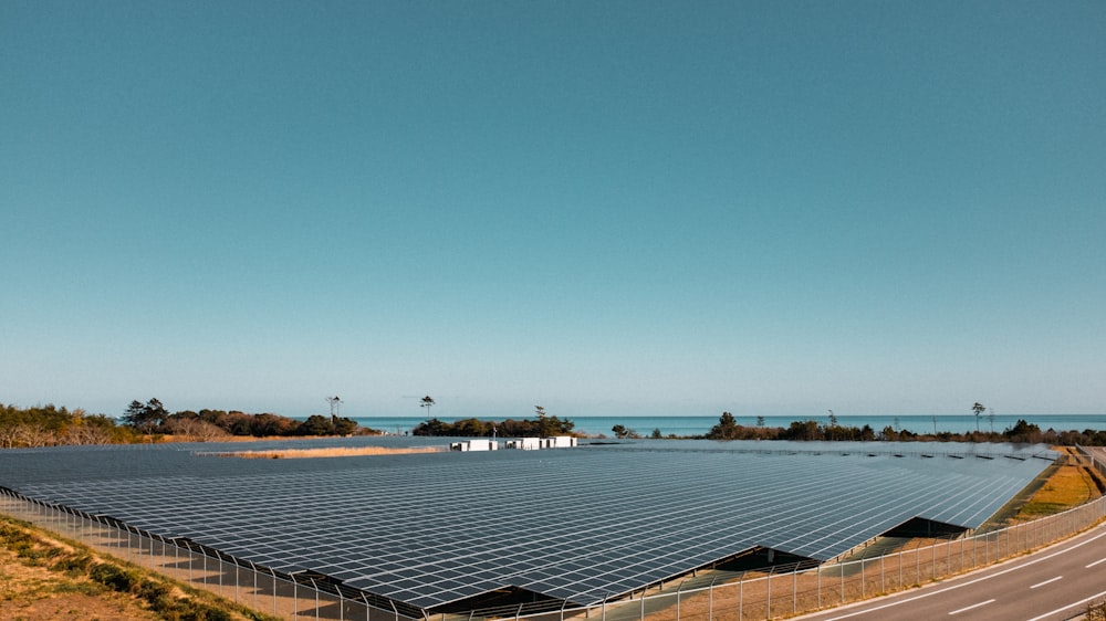 a large solar power plant sitting on the side of a road