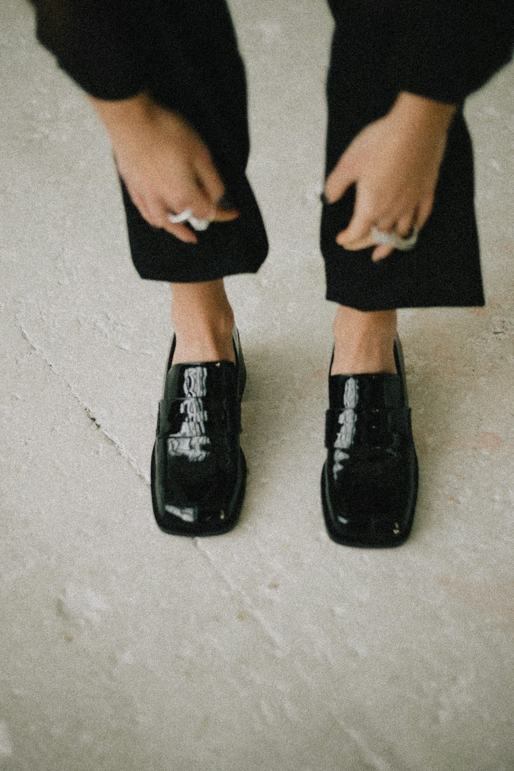 a close up of a person wearing black shoes