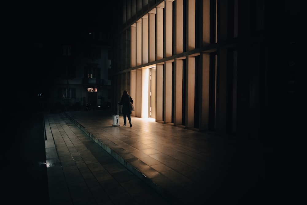 two people standing in front of a building at night