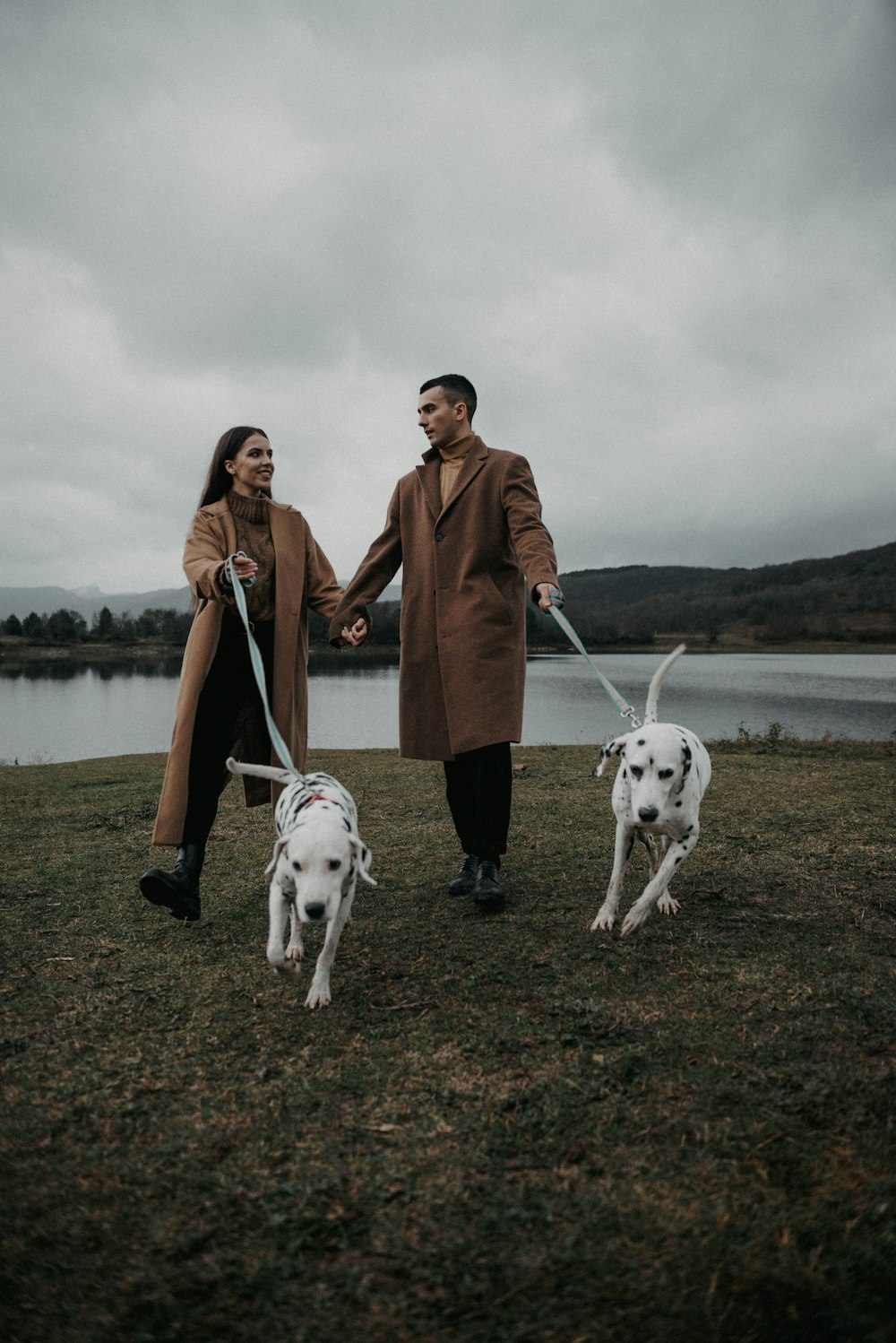 a man and a woman standing next to a dog