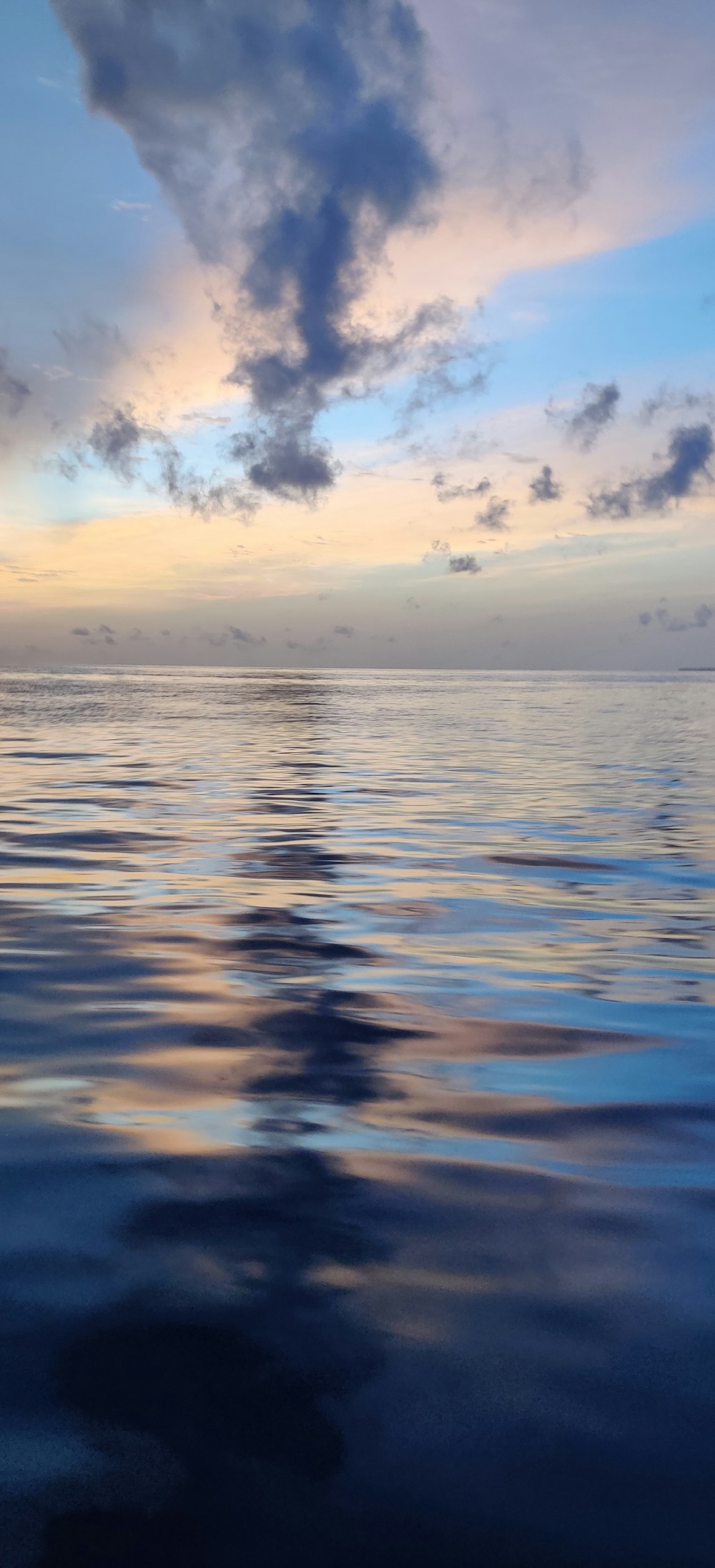 a large body of water under a cloudy sky