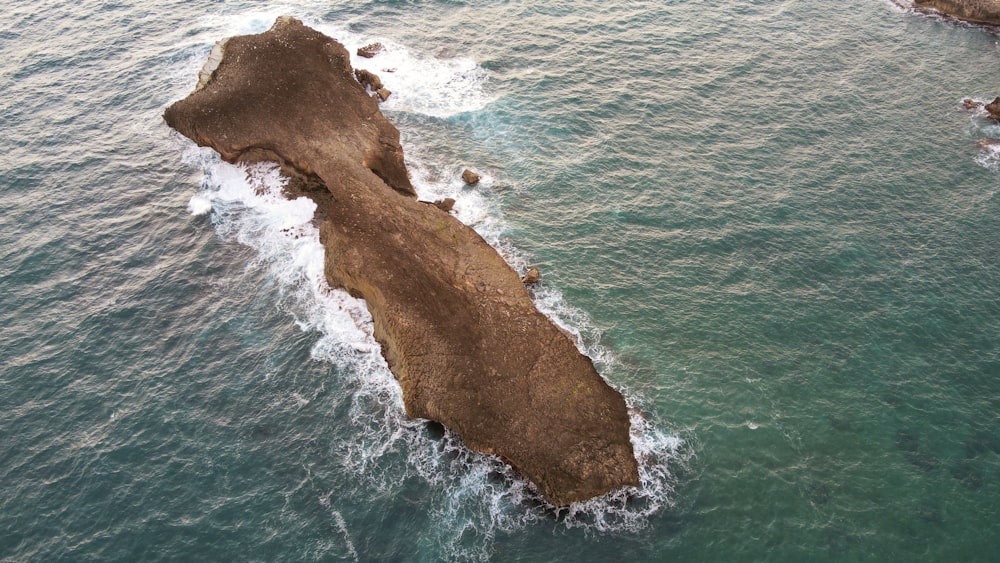 an aerial view of a rock formation in the ocean