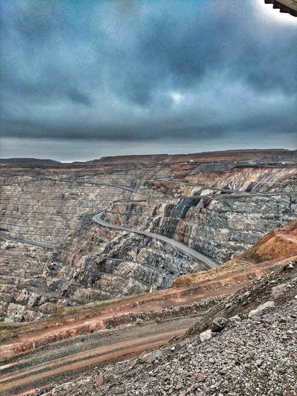 Gold mine canyon and mining trucks