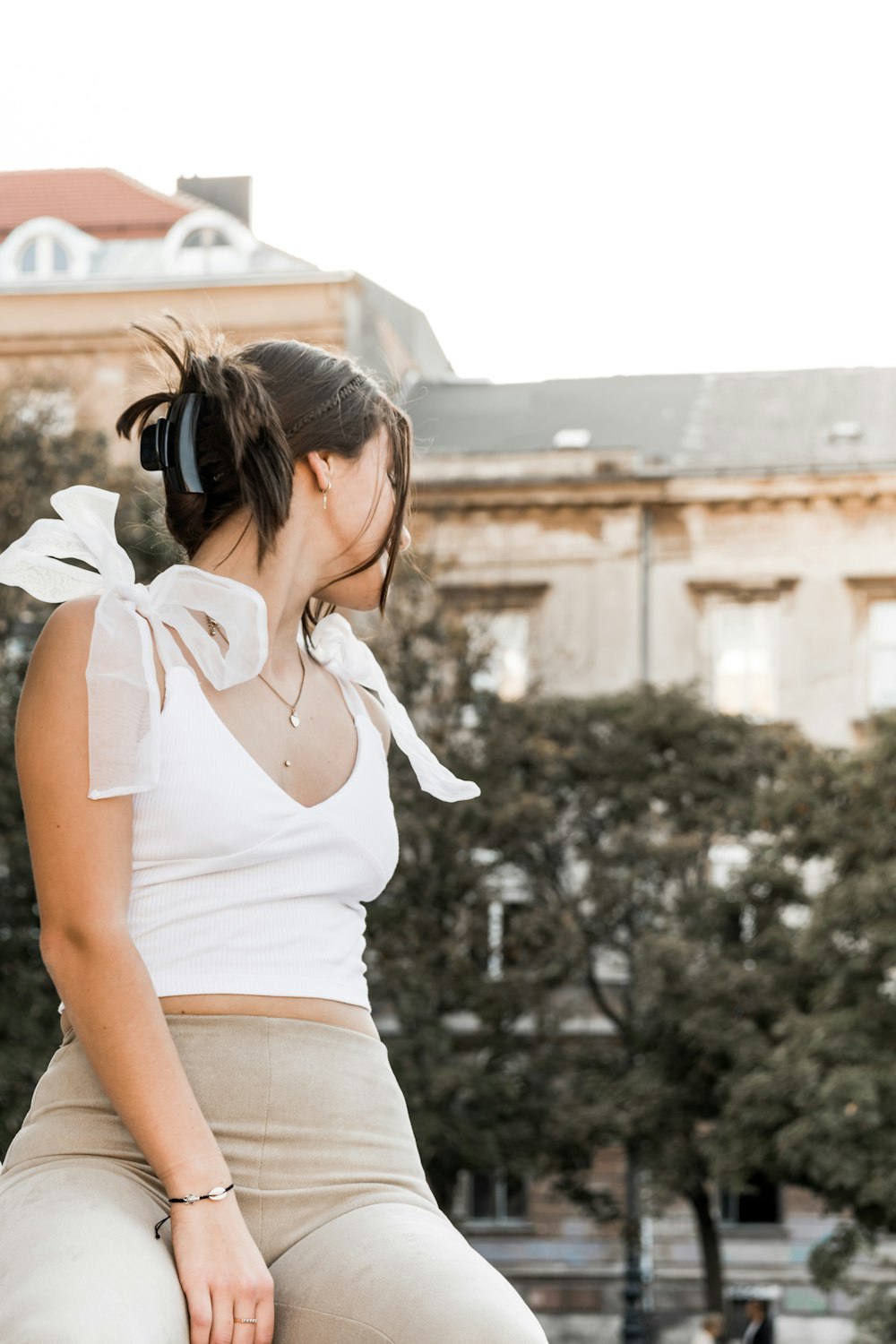 a woman sitting on top of a skateboard