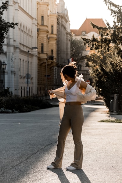 a woman standing in the middle of a street