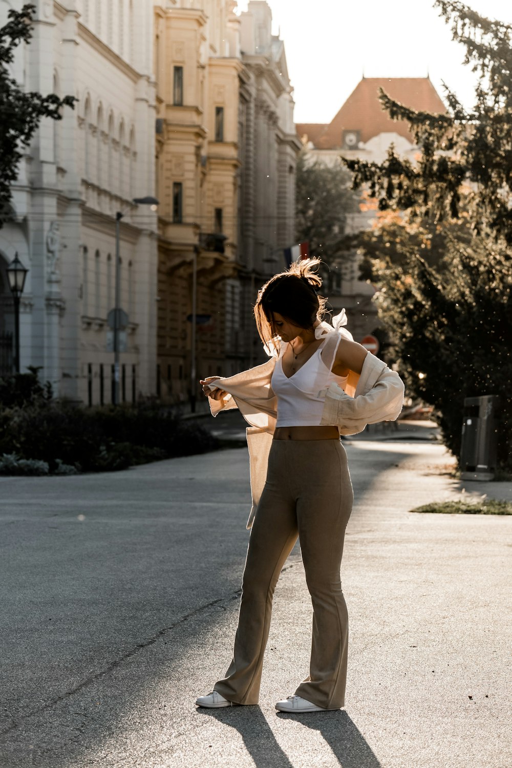 a woman standing in the middle of a street