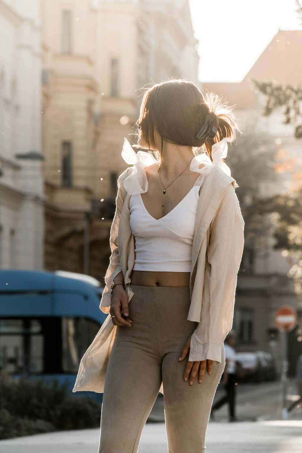 a woman is standing on a skateboard on the street