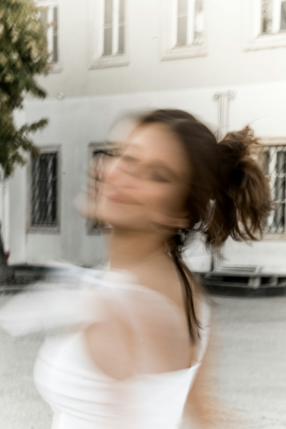 a blurry photo of a woman in a white dress