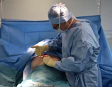a person in a hospital gown operating a machine
