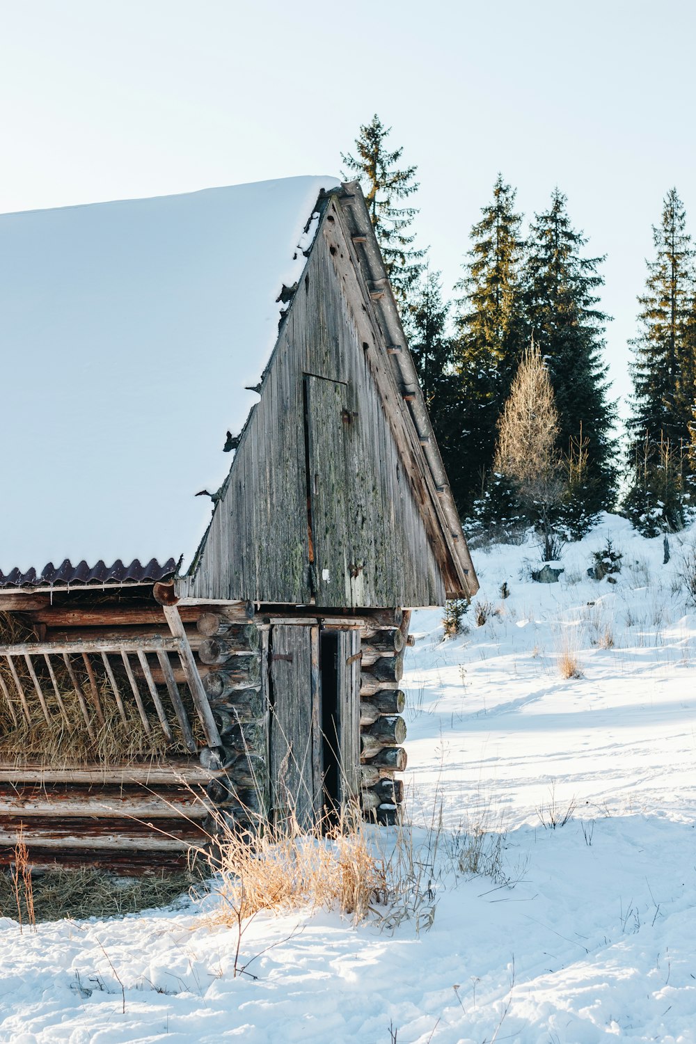 an old wooden building in the snow