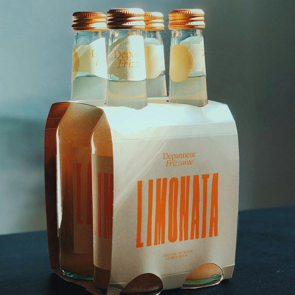 a couple of bottles of lemonade sitting on top of a table