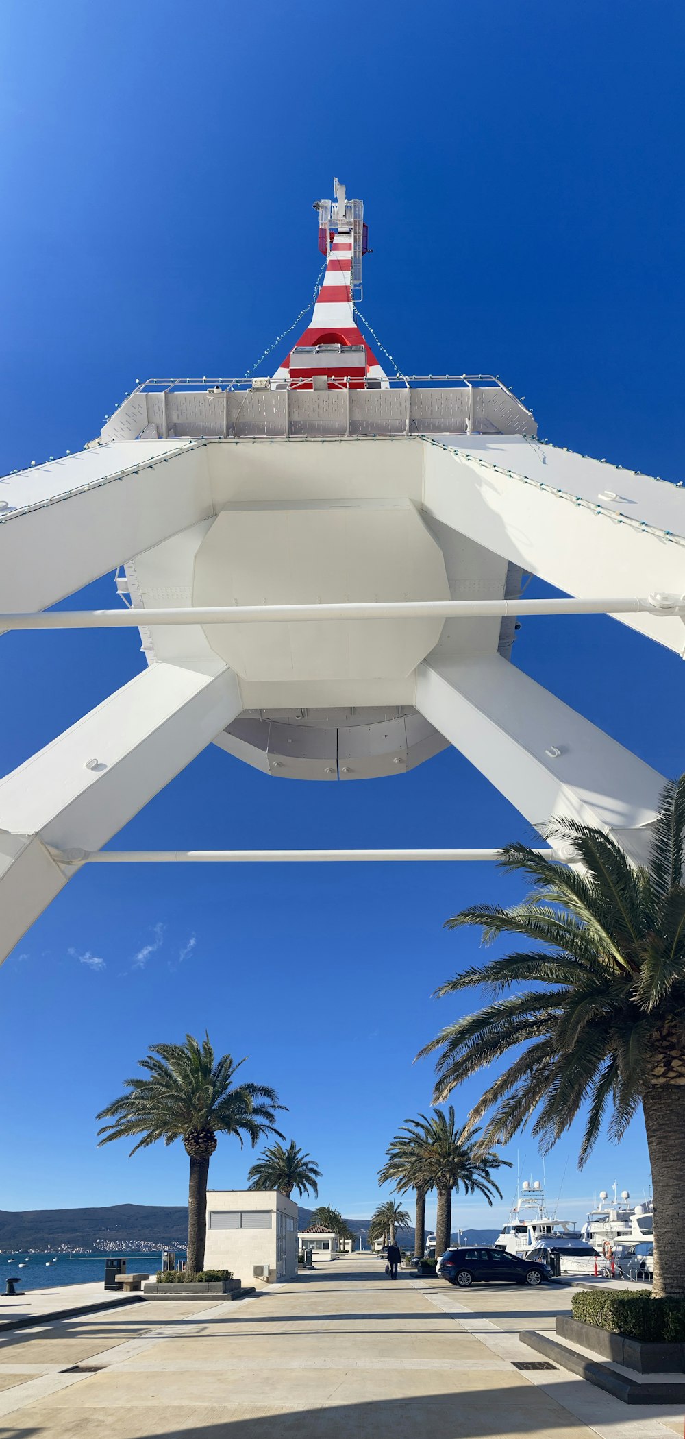 a red and white lighthouse on top of a white structure