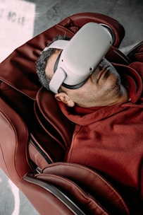 a man laying on a chair wearing a virtual reality headset