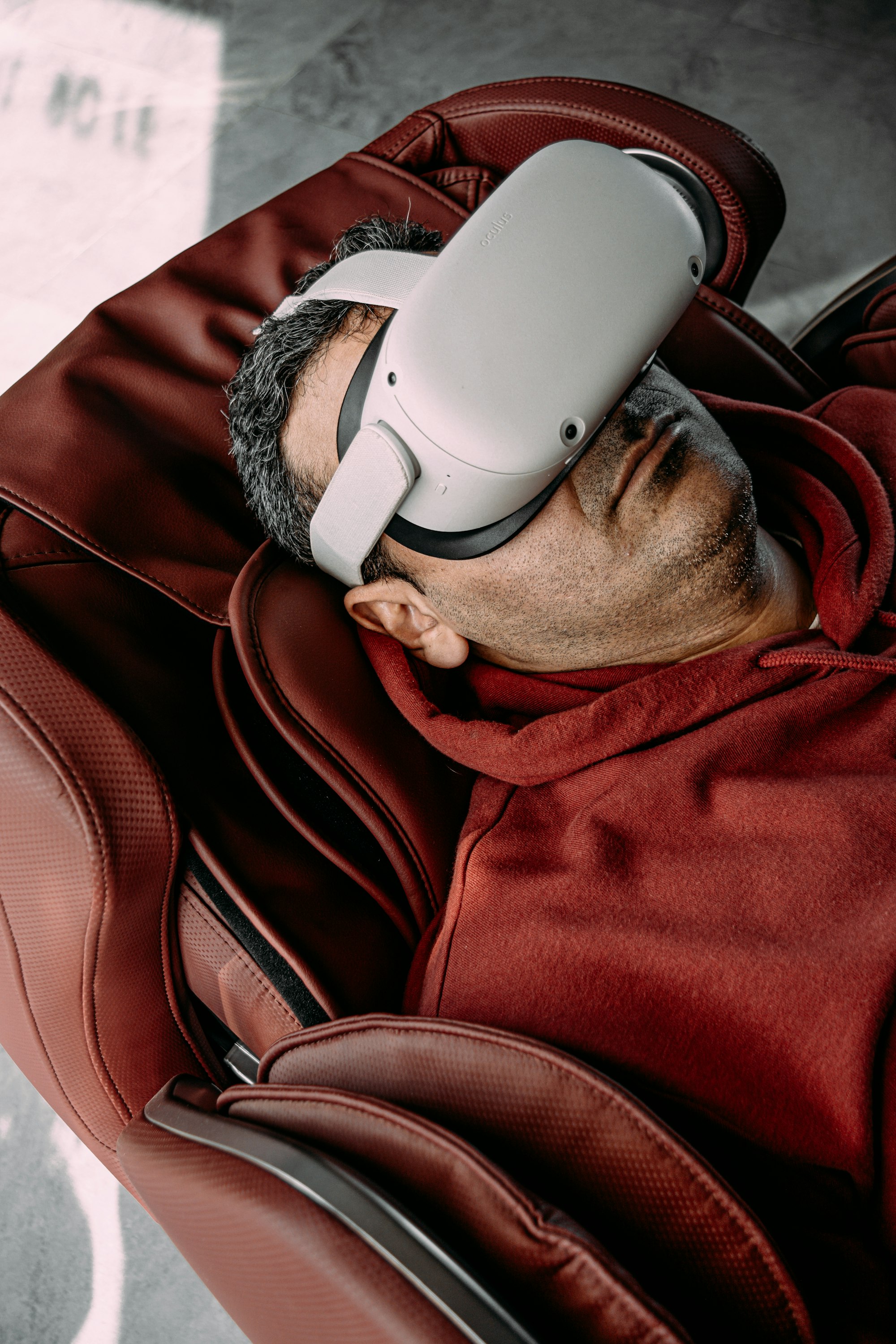 a man laying on a chair wearing a virtual reality headset