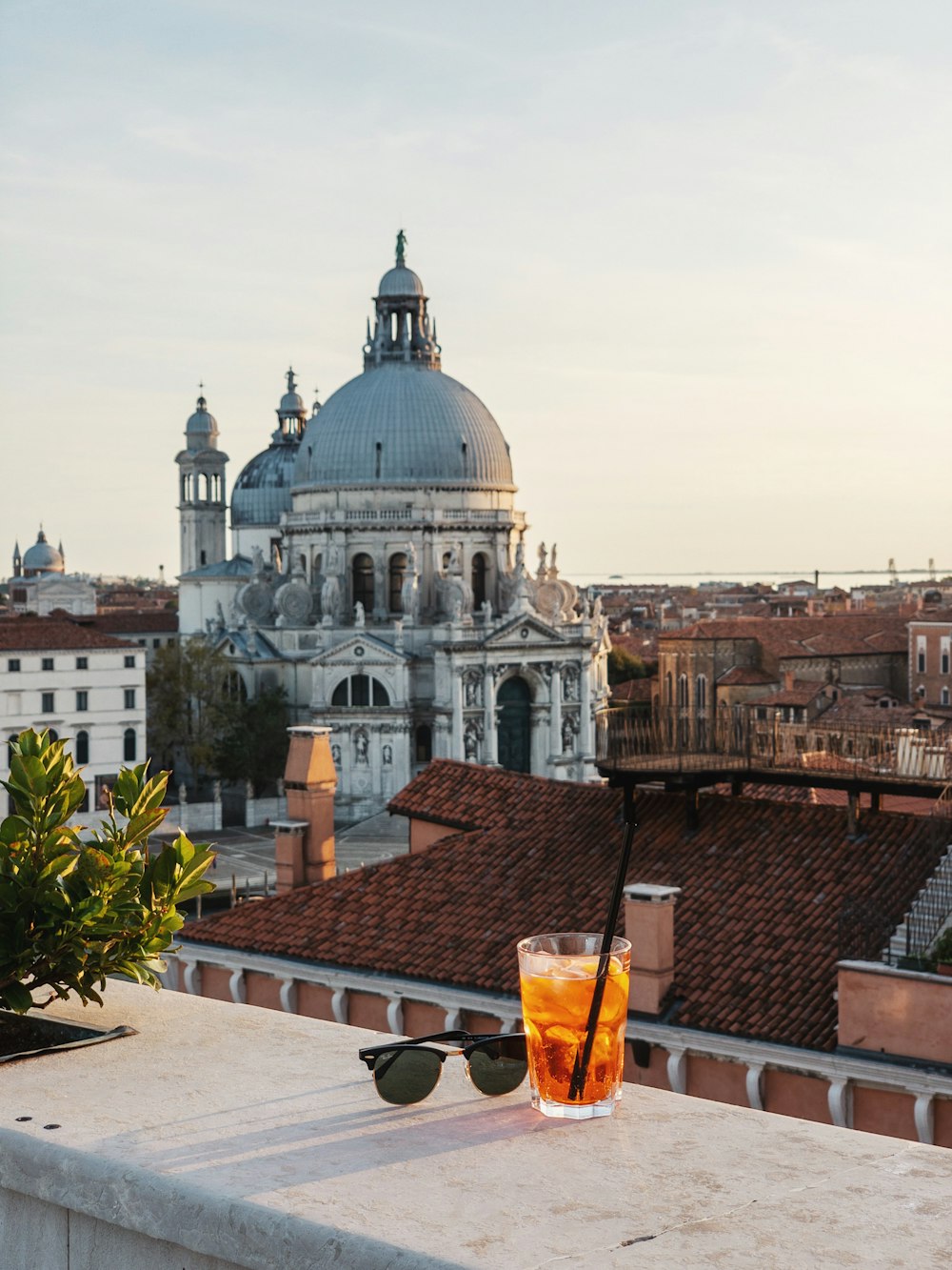 a glass of orange juice sitting on top of a roof