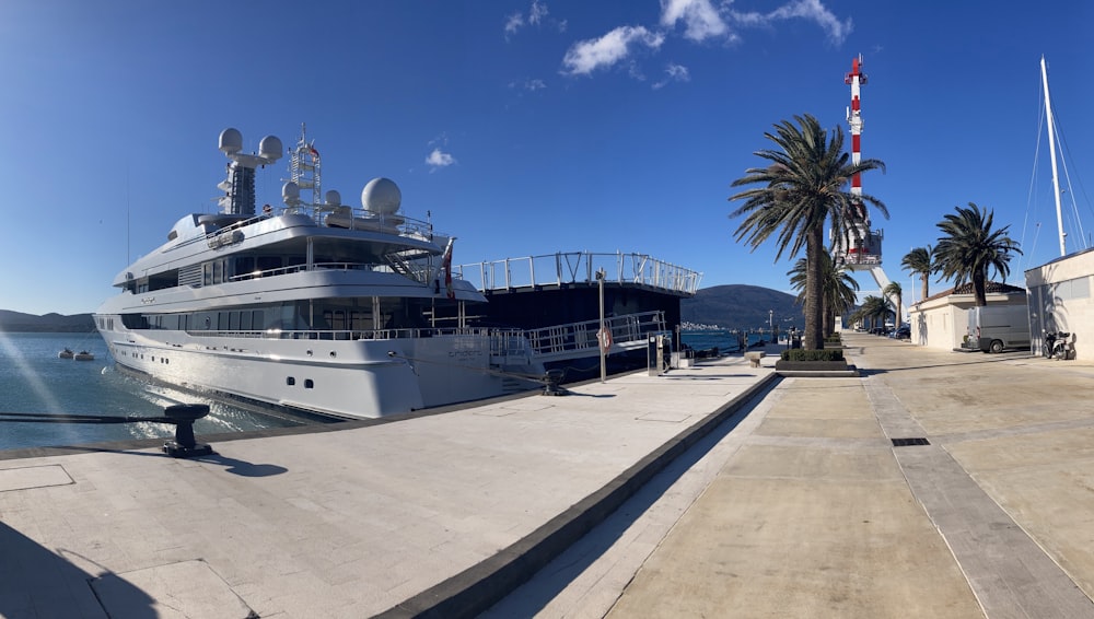 a large white boat docked at a dock