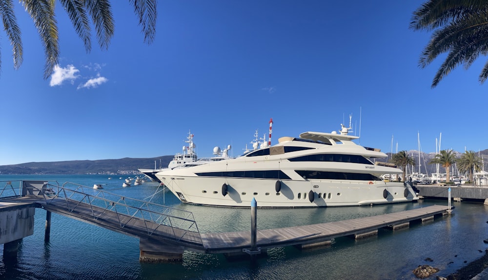 a large white boat docked at a dock