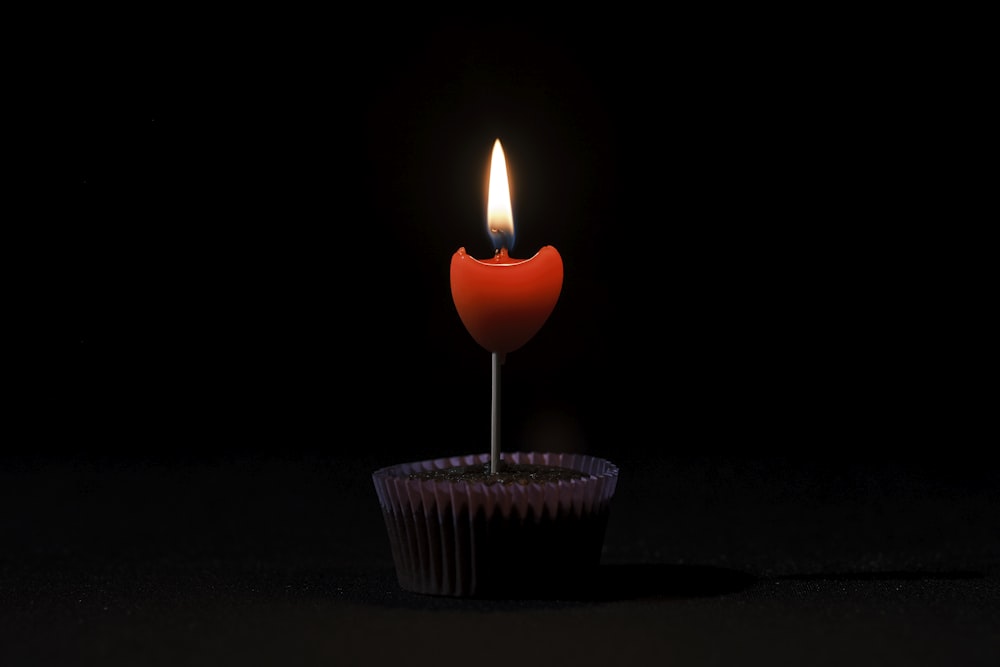 un cupcake con una candela che spunta da esso