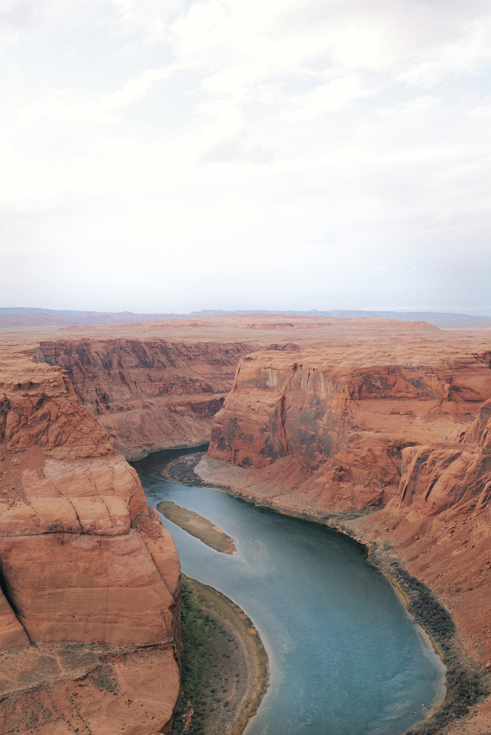 a river running through a canyon surrounded by mountains