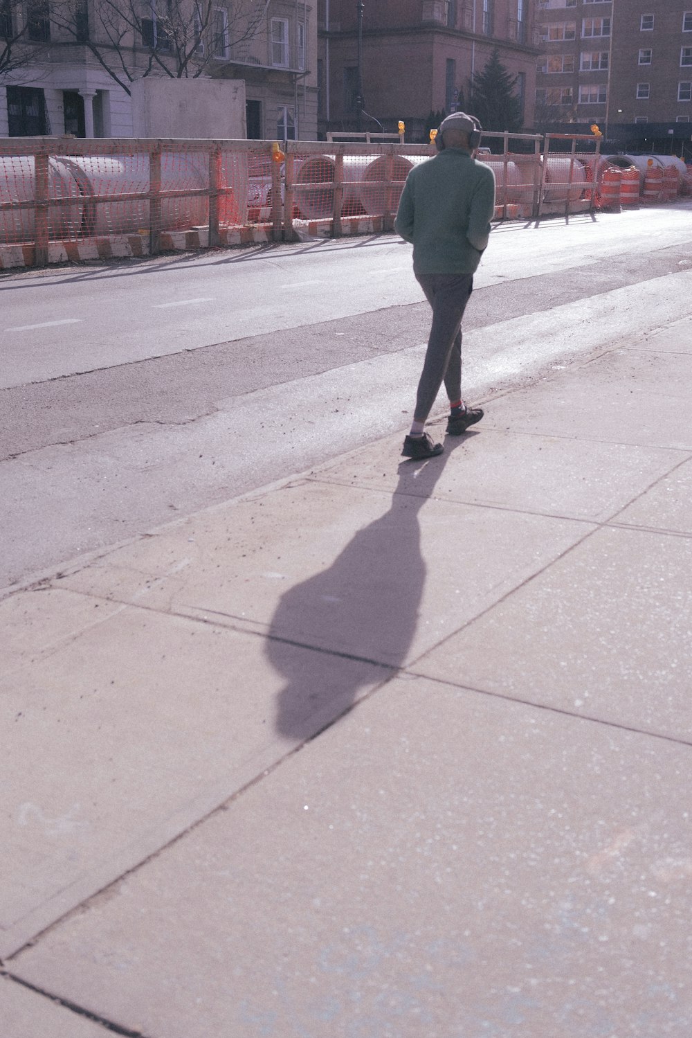 a man riding a skateboard down a sidewalk