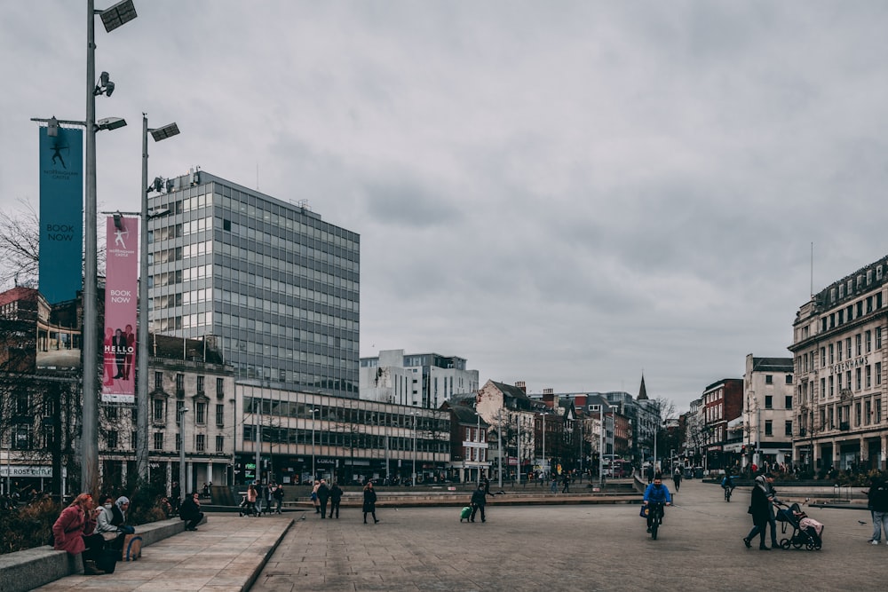 a group of people walking around a city square