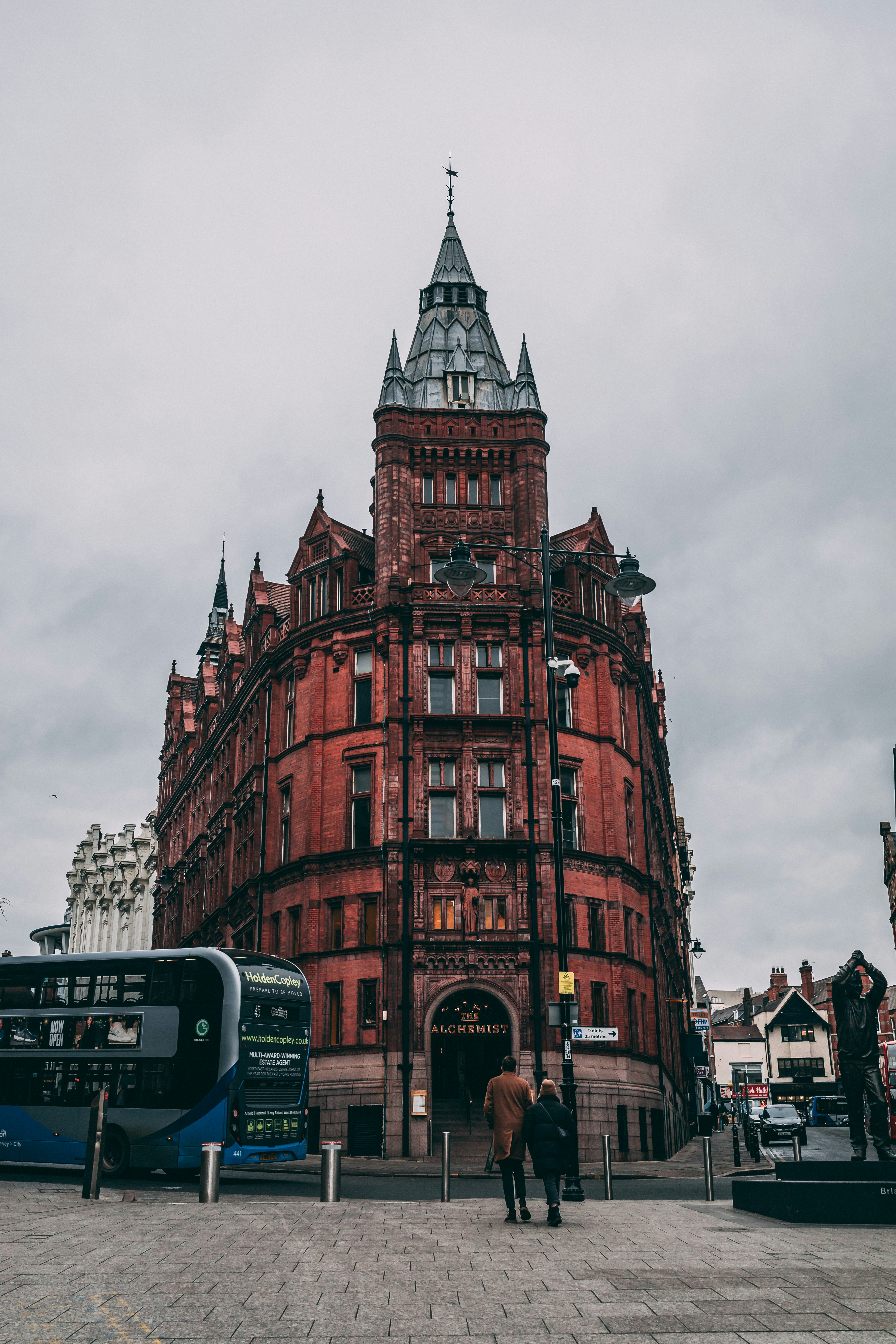 two people standing in front of a large building