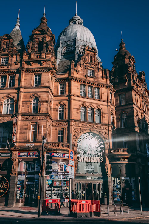 Clock-fronted city-centre building in Leeds seen from street level