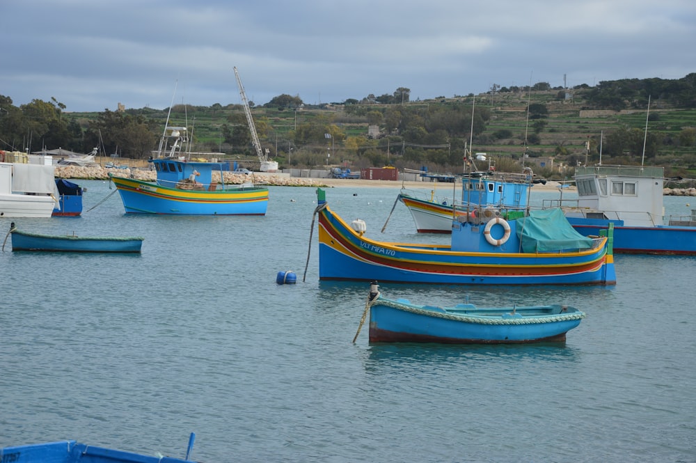 a group of boats floating on top of a body of water