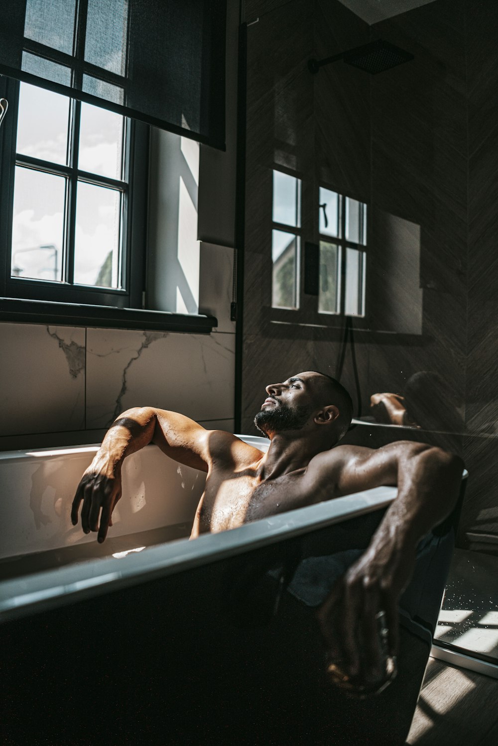 a man is taking a bath in a bathtub