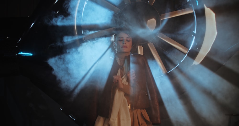 a woman standing in front of a giant wheel