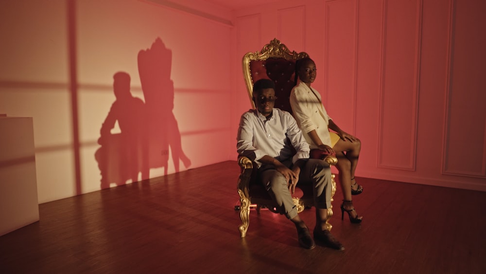 a man and a woman sitting in a chair
