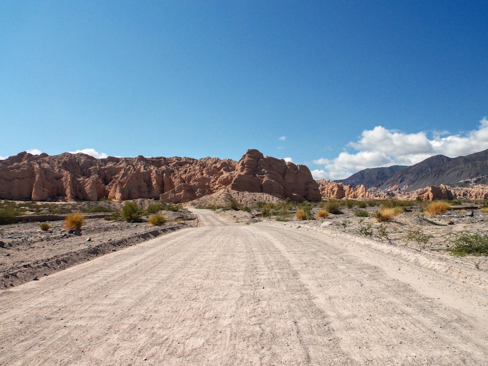 a dirt road in the middle of a desert