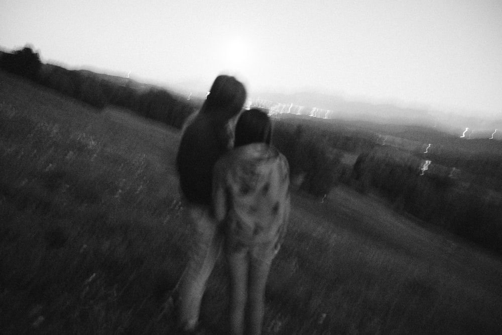 a couple of people standing in a field