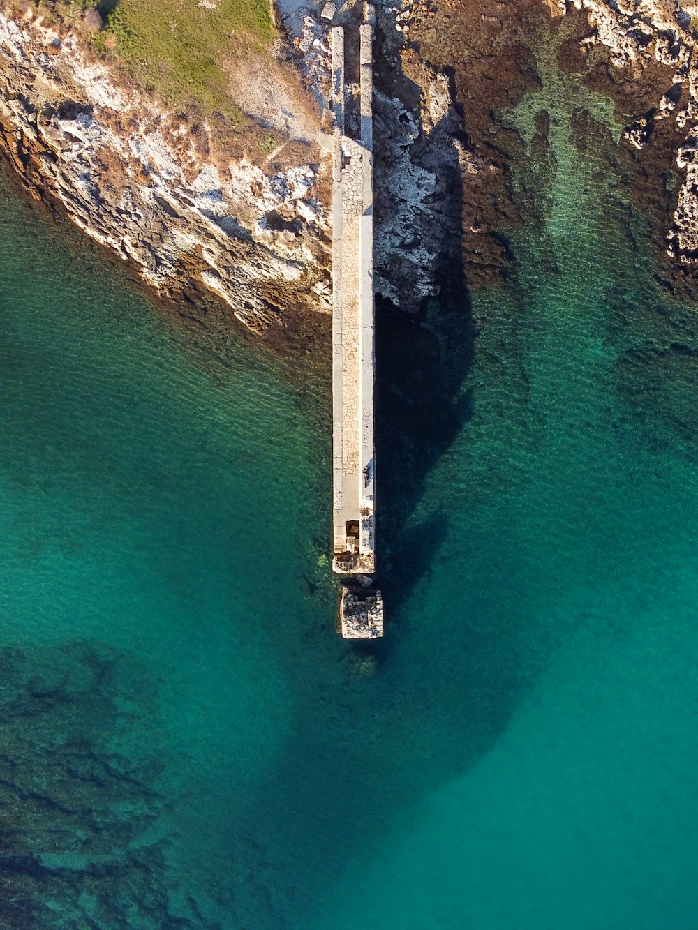 an aerial view of a bridge over a body of water