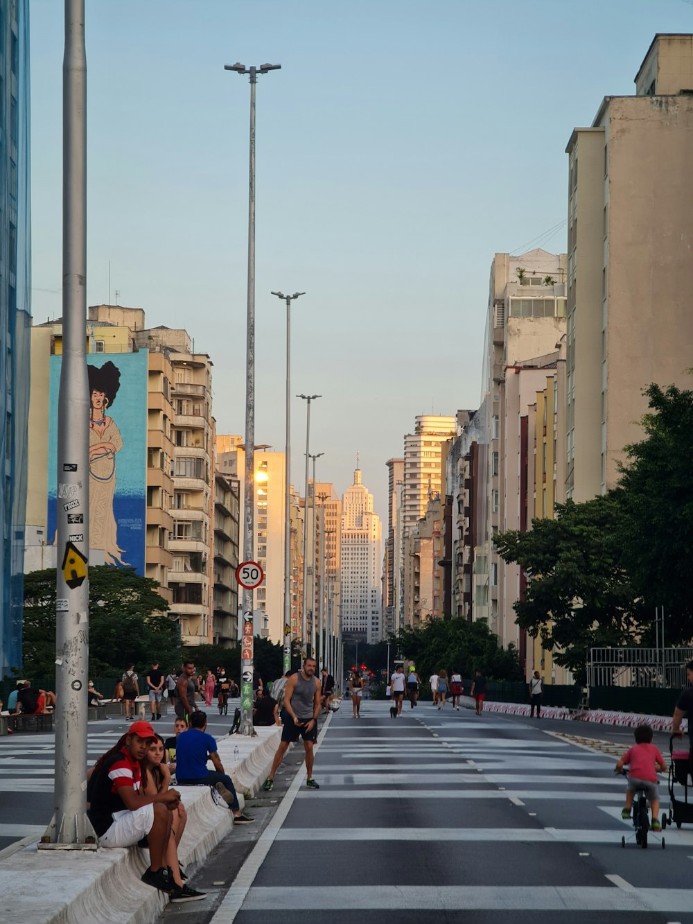 a group of people sitting on the side of a road