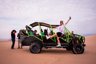 a man riding on the back of a green four wheeled vehicle