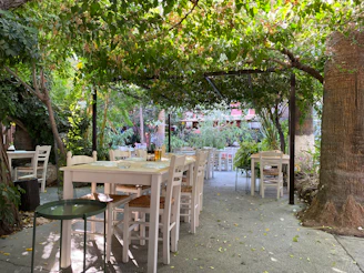 an outdoor dining area with tables and chairs