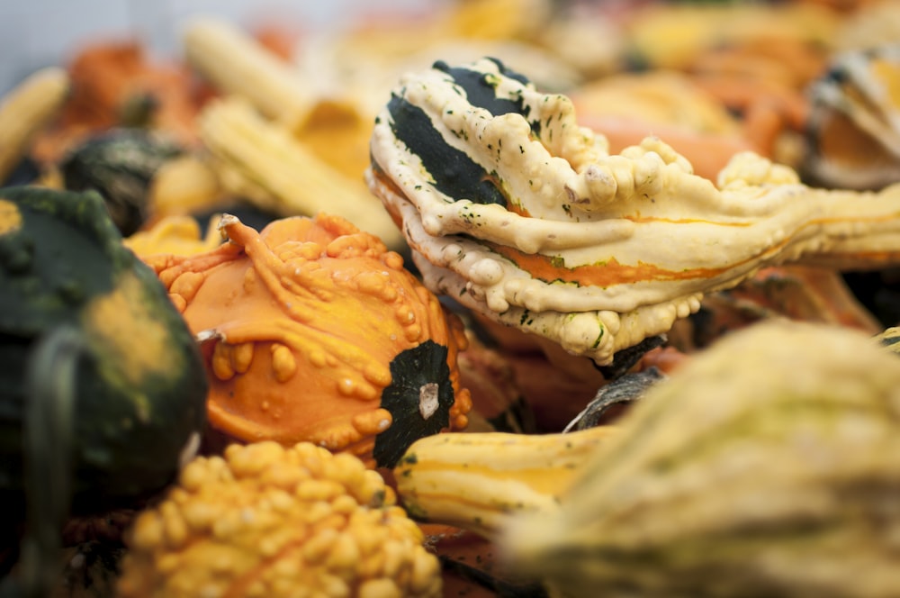 a close up of a bunch of gourds and squash