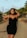 a woman in a black dress posing for a picture