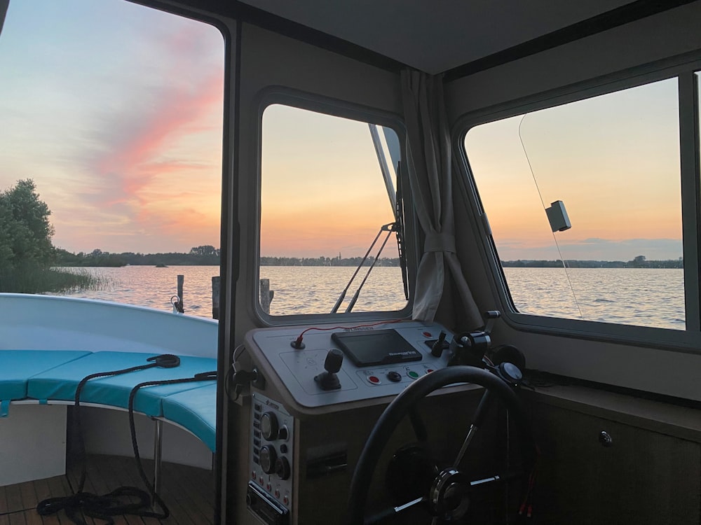 the inside of a boat with a steering wheel