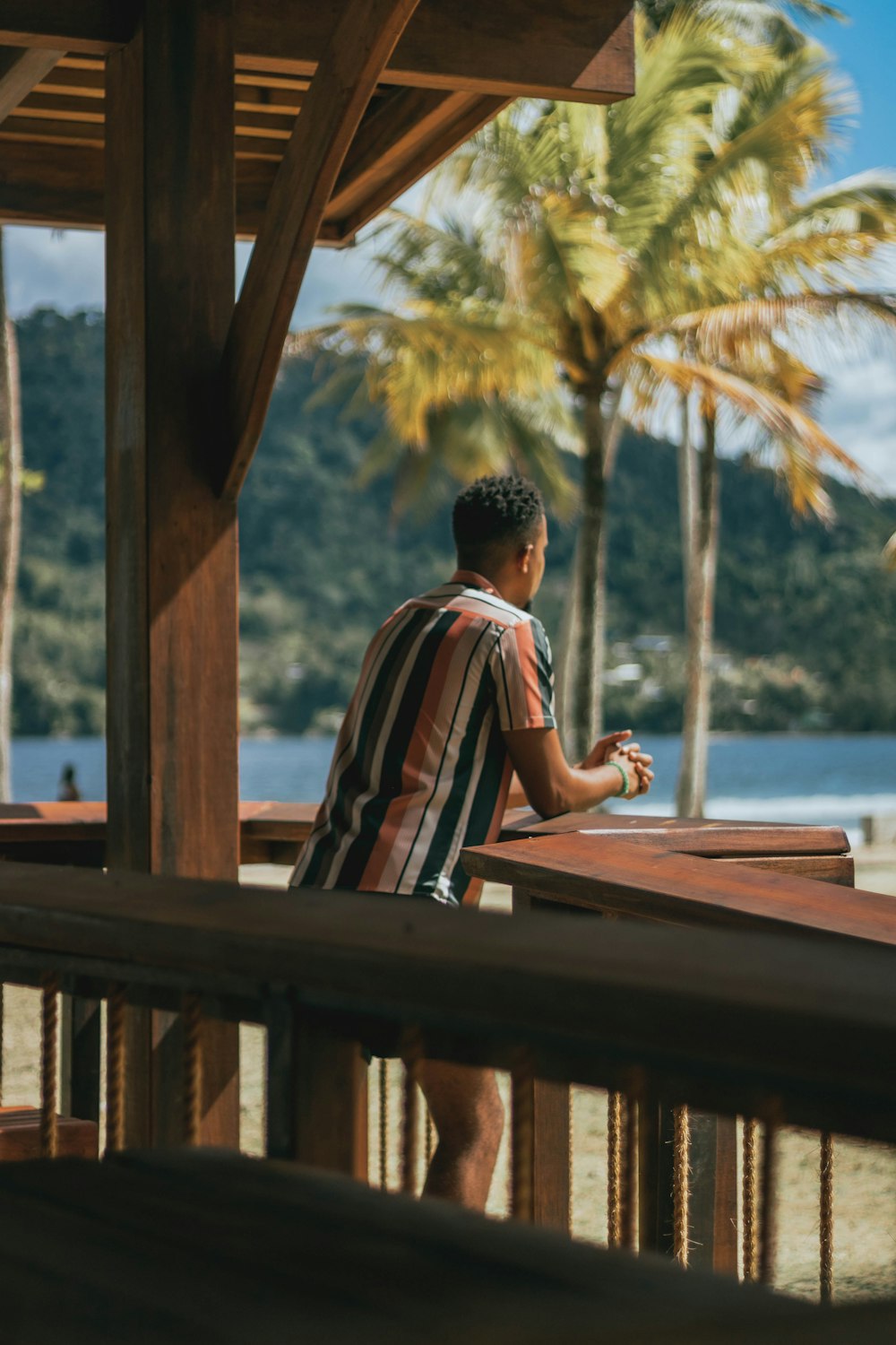 a man standing on a deck looking at his cell phone