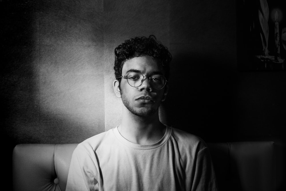 a black and white photo of a man wearing glasses