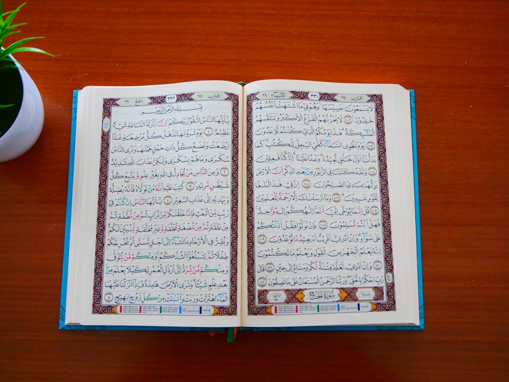 an open book sitting on top of a wooden table