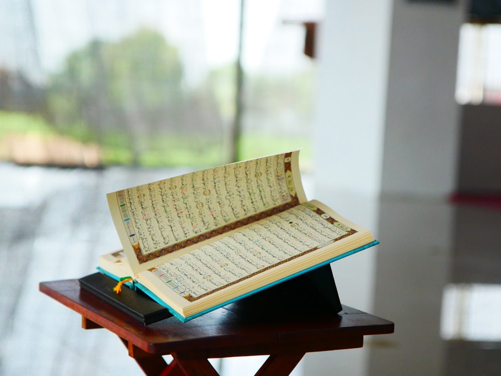 an open book sitting on top of a wooden table