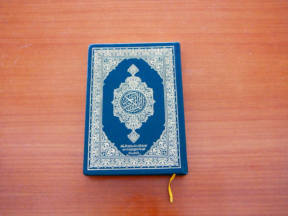 a blue and white book sitting on top of a wooden table