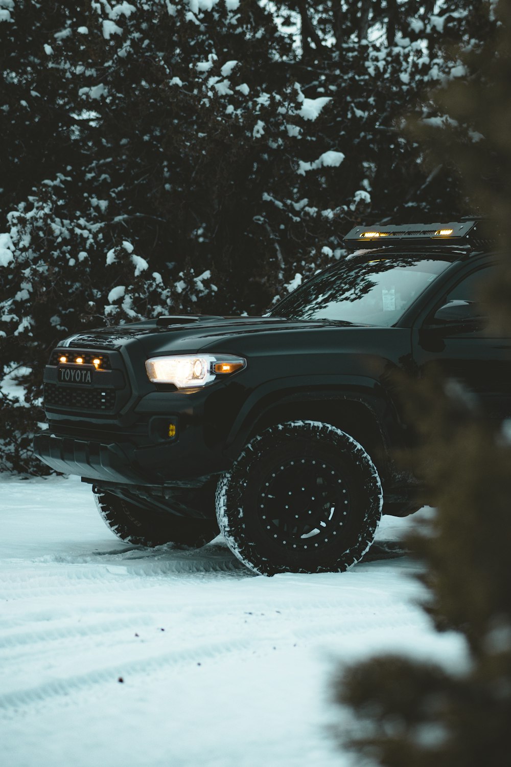 a black truck is parked in the snow