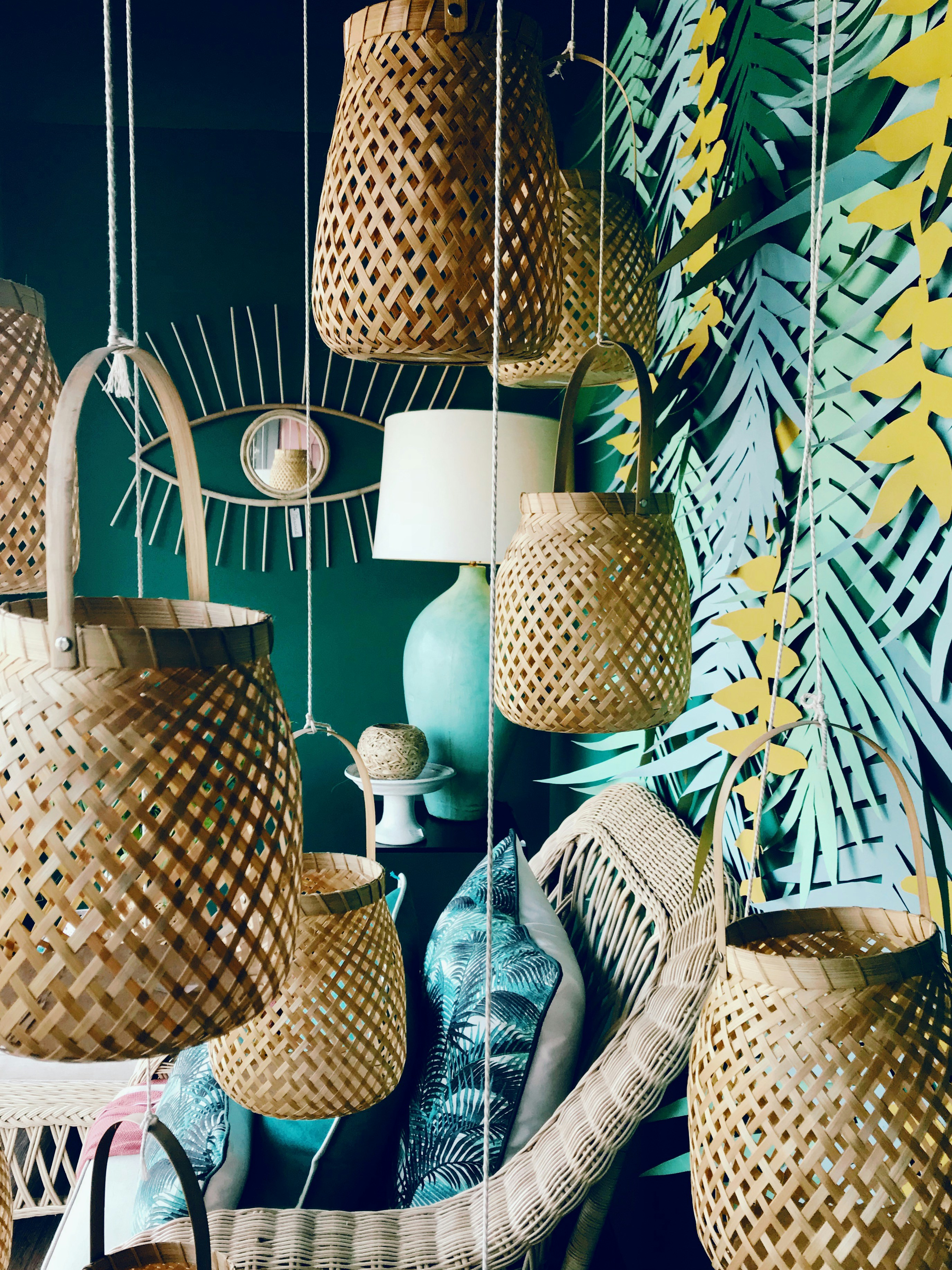 a room filled with lots of hanging wicker baskets