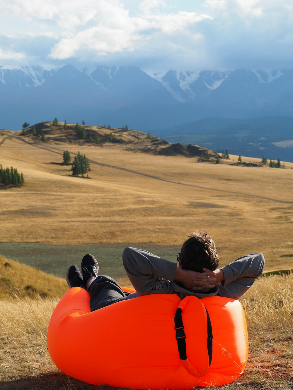 a man laying on an inflatable tube in the middle of a field